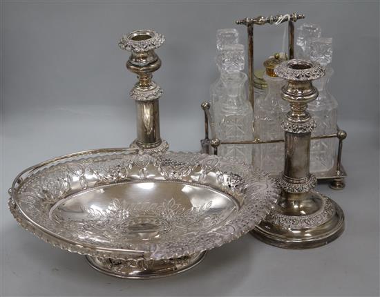 A pair of plated telescopic candlesticks, a cruet stand and a basket